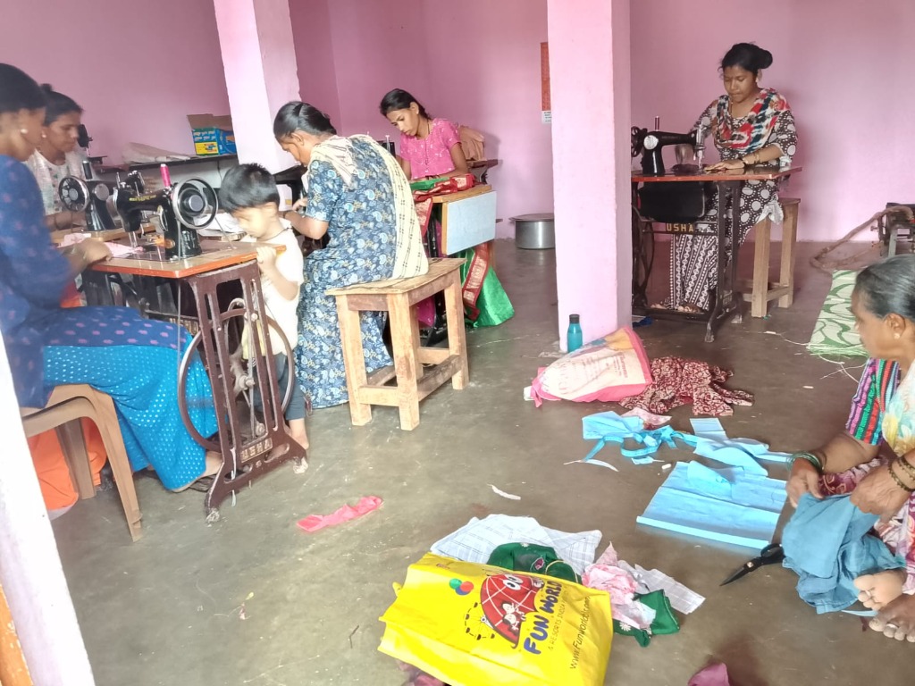 Indian women studying sewing machines